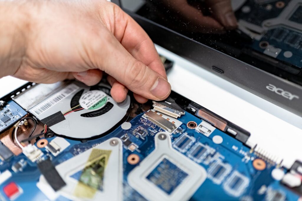 A Person Holding a Connector Tab on the Circuit Board